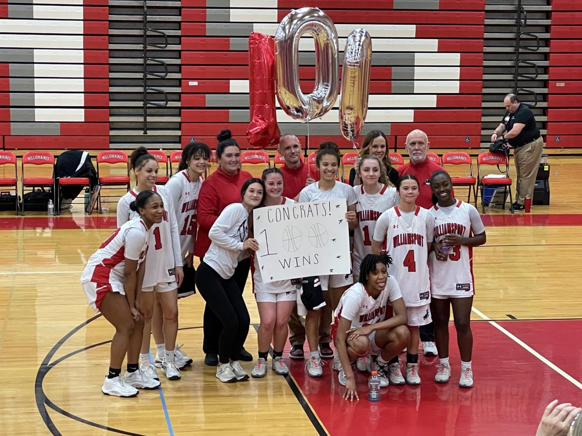 Girls team honors Coach Marnons 100th career win. 