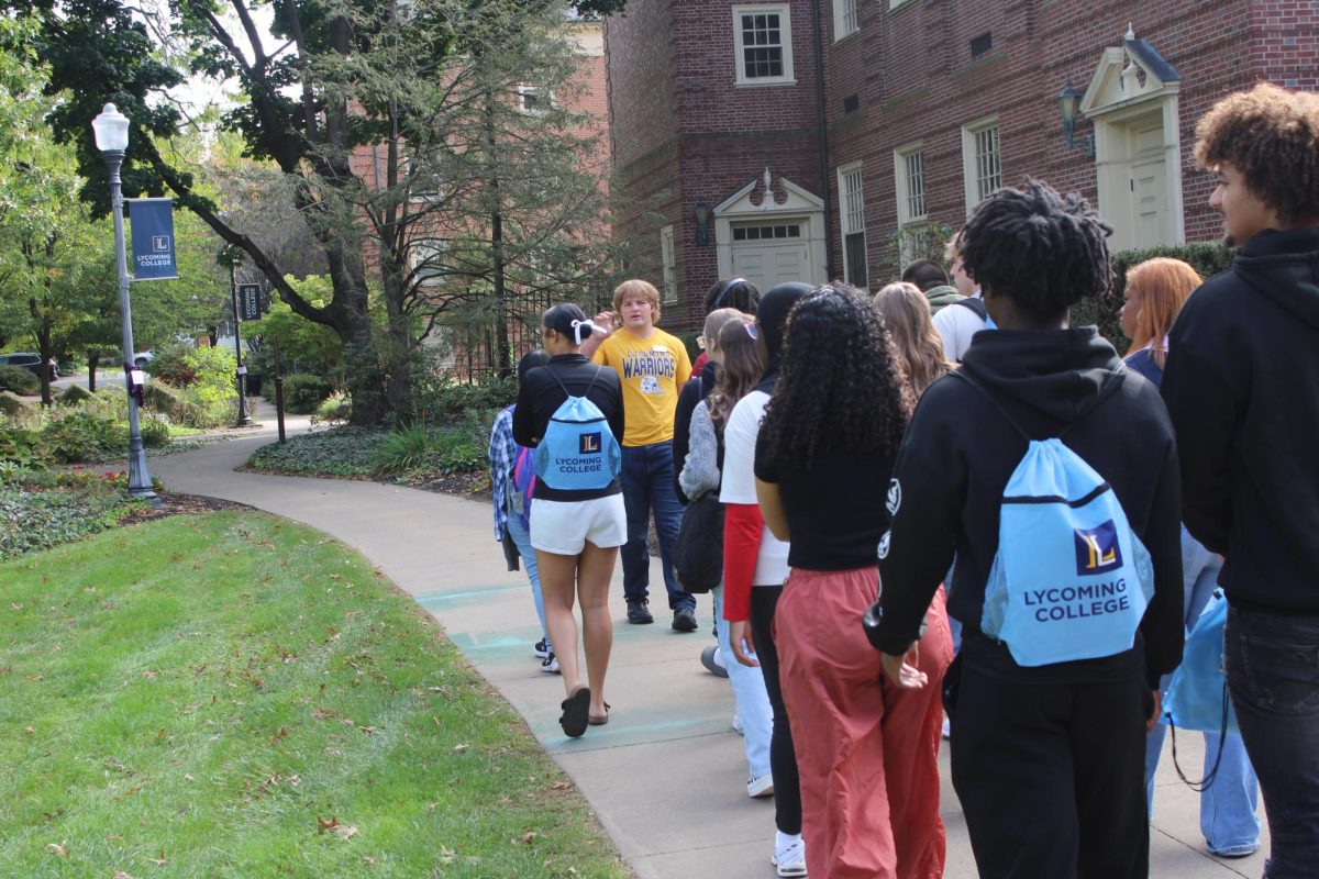 Student Mike Sipps '26 leads seniors on a tour around Lycoming College.