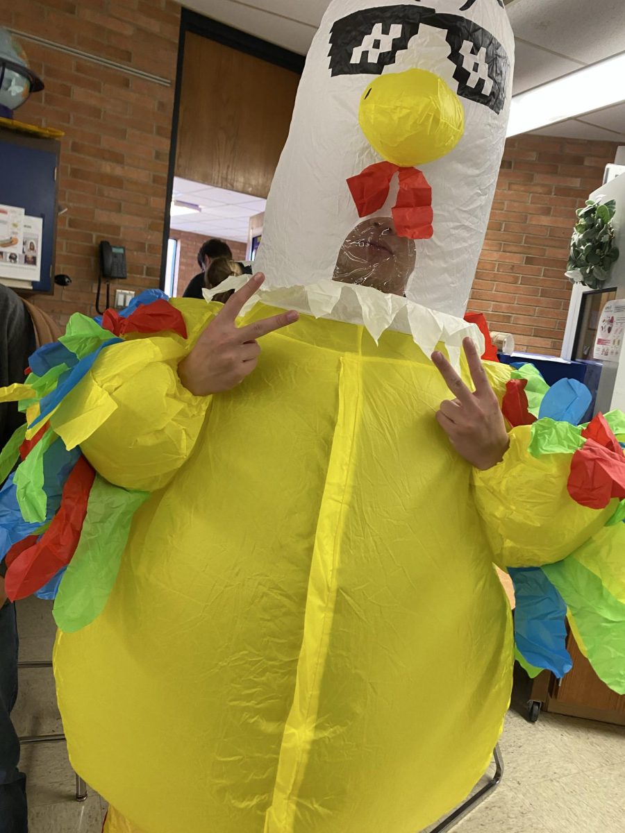 Austin Chen dresses up in a giant inflatable chicken costume.